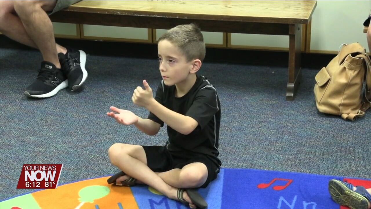 Children are learning basics of the American Sign Language at Lima Public Library
